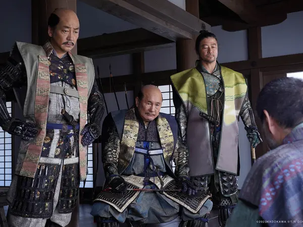 Three men in traditional Japanese samurai armour and clothing, standing in an interior setting.